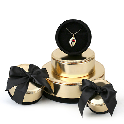 China Round Champagne Gold Fancy Jewelry Box With Ribbon PU Leather Chipboard supplier
